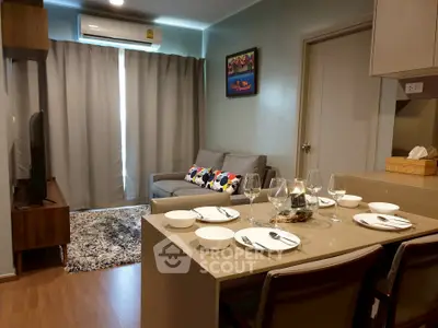 Modern living room with dining area, featuring cozy sofa, stylish decor, and air conditioning.