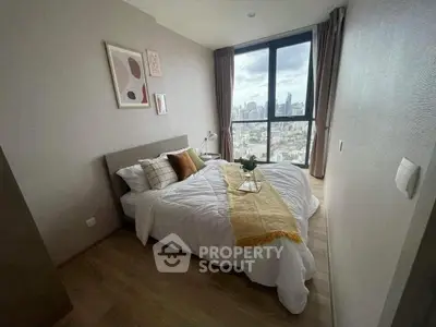 Modern bedroom with city view, featuring cozy bed and stylish decor in high-rise apartment.