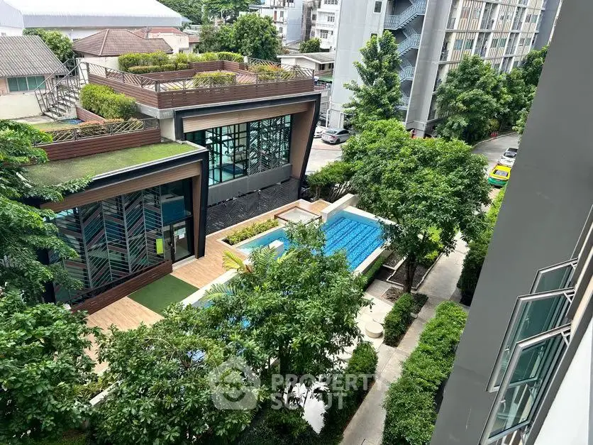 Modern residential complex with pool and lush greenery view