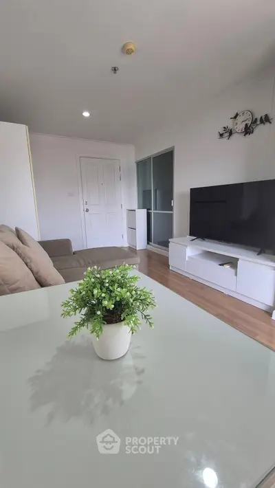 Modern living room with sleek TV setup and cozy sofa, perfect for relaxation.