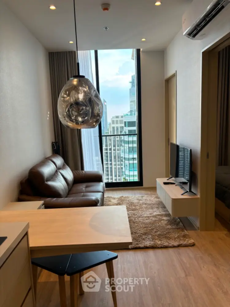Modern living room with city view, stylish decor, and cozy seating area.