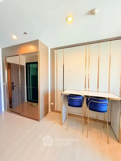Modern study area with sleek desk and chairs, featuring stylish storage solutions.
