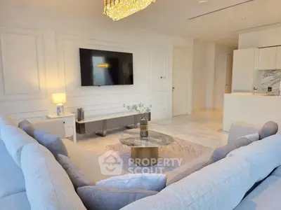 Luxurious living room with modern decor and open kitchen layout