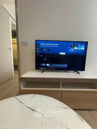 Modern living room with sleek TV setup and stylish furniture, perfect for contemporary living.