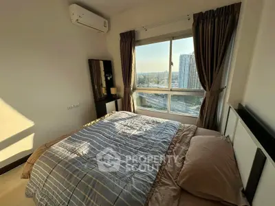 Cozy bedroom with large window offering stunning city view