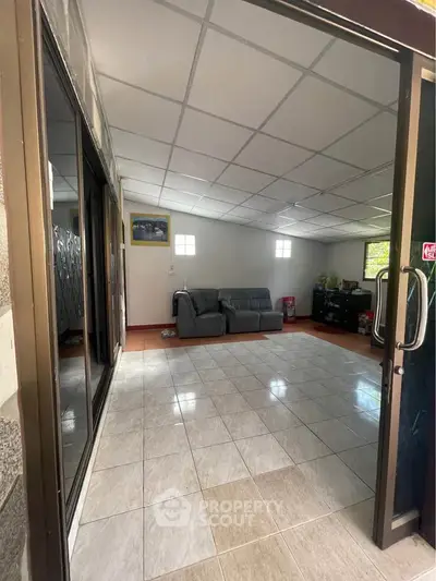 Spacious tiled living room with cozy sofa and modern decor