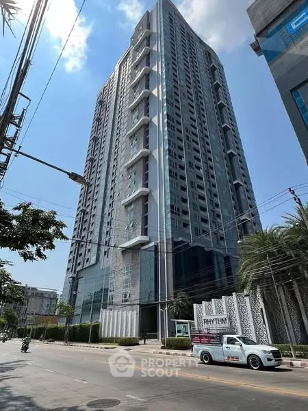 Modern high-rise building with sleek design and urban surroundings.
