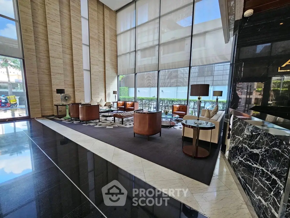 Luxurious building lobby with elegant seating and floor-to-ceiling windows