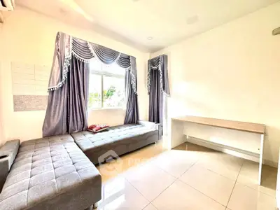Bright living room with elegant curtains and modern furniture, perfect for relaxation and comfort.