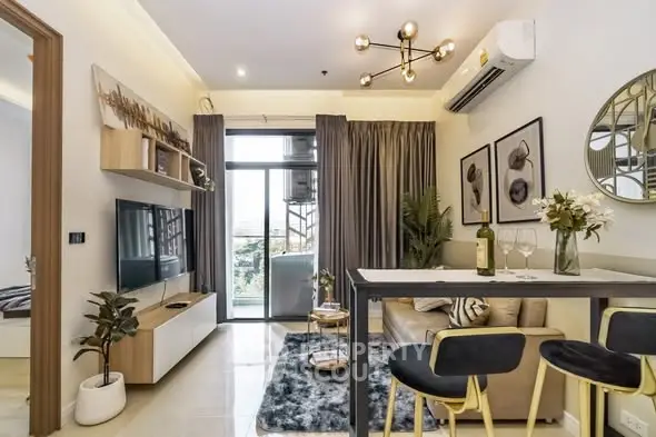 Modern living room with stylish decor and balcony view in a contemporary apartment.