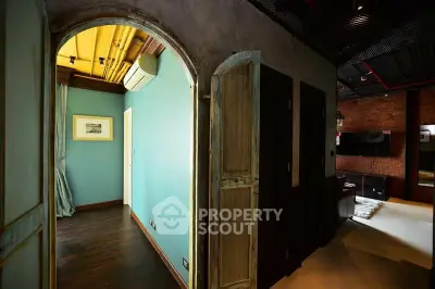 Stylish interior with rustic doors and modern decor in a cozy living space.