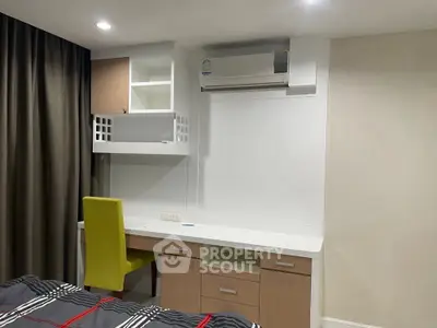 Modern bedroom with built-in desk and air conditioning, perfect for comfortable living.