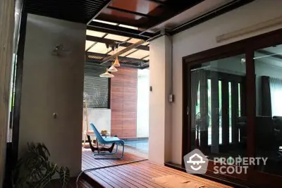 Luxurious indoor-outdoor living space with modern design and elegant wooden flooring.