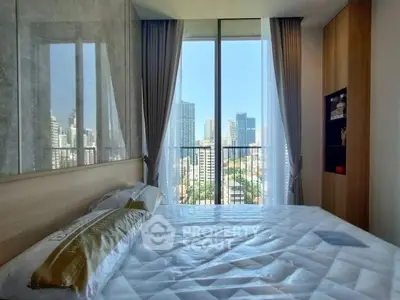 Modern bedroom with city view and large windows in high-rise apartment