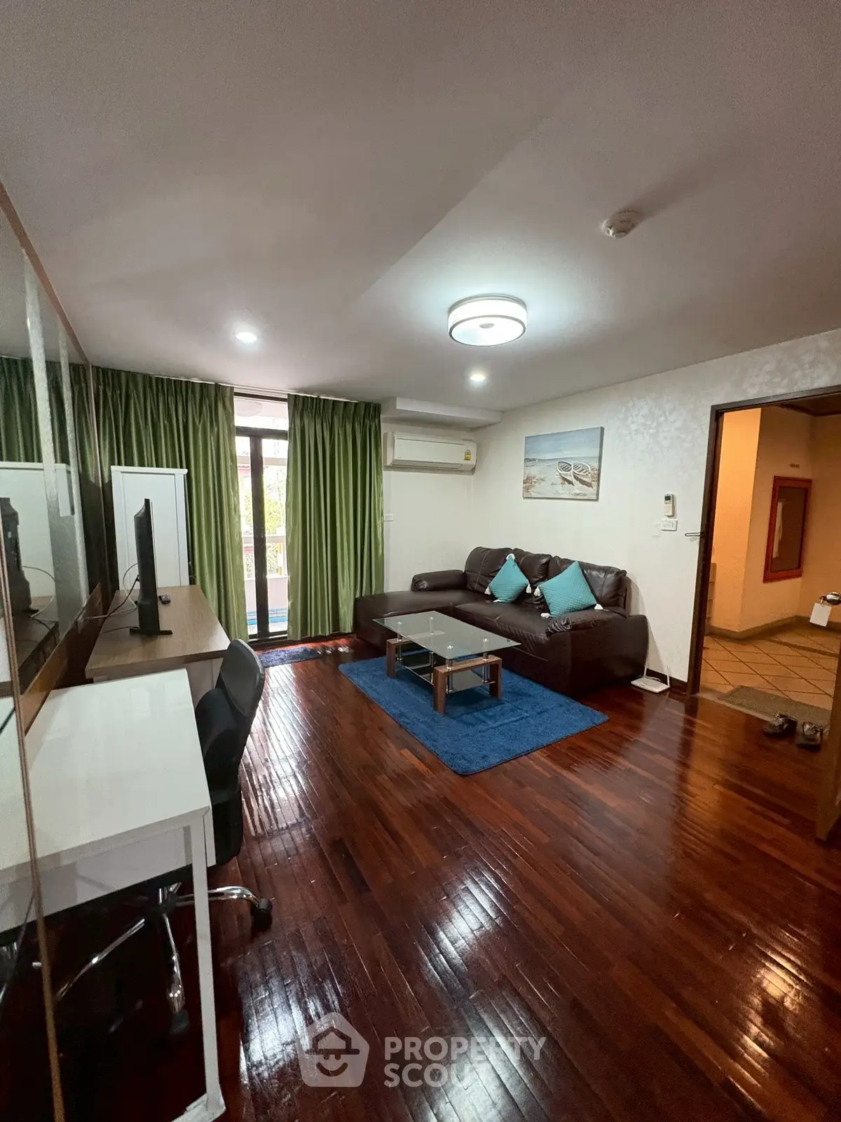 Spacious living room with modern decor and wooden flooring