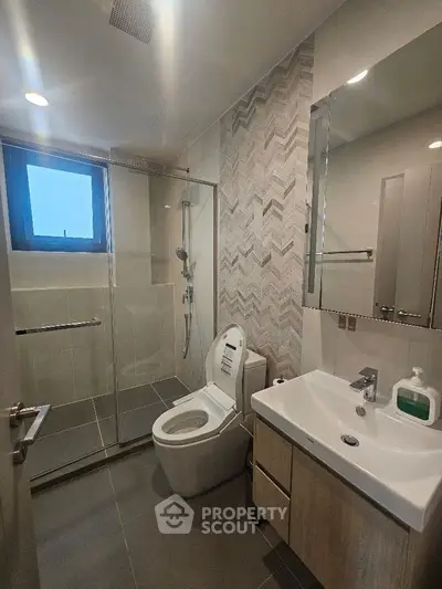 Modern bathroom with glass shower and sleek fixtures