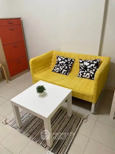 Cozy living room with vibrant yellow sofa and modern decor