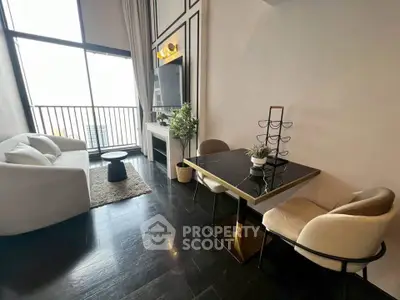 Modern living room with high ceilings and elegant decor, featuring a cozy seating area and stylish dining space.