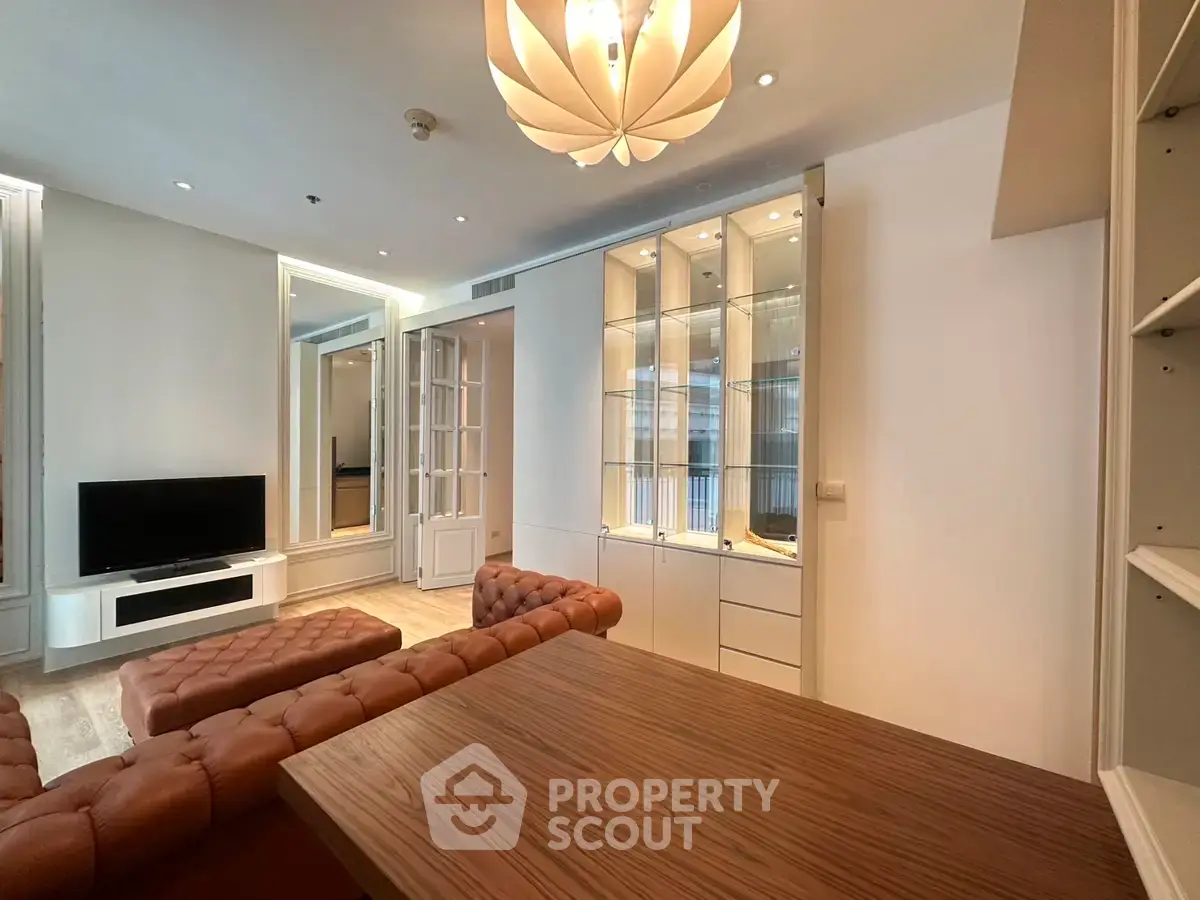 Elegant living room with modern lighting and stylish furniture in a luxurious apartment.