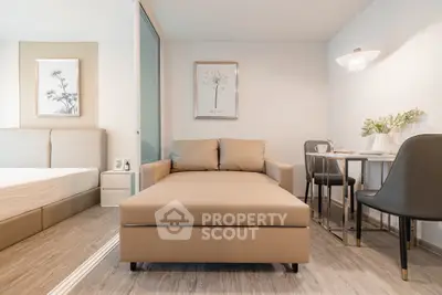 Modern studio apartment with stylish decor and cozy seating area