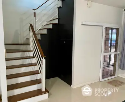 Modern staircase with sleek railing and polished flooring in a contemporary home interior