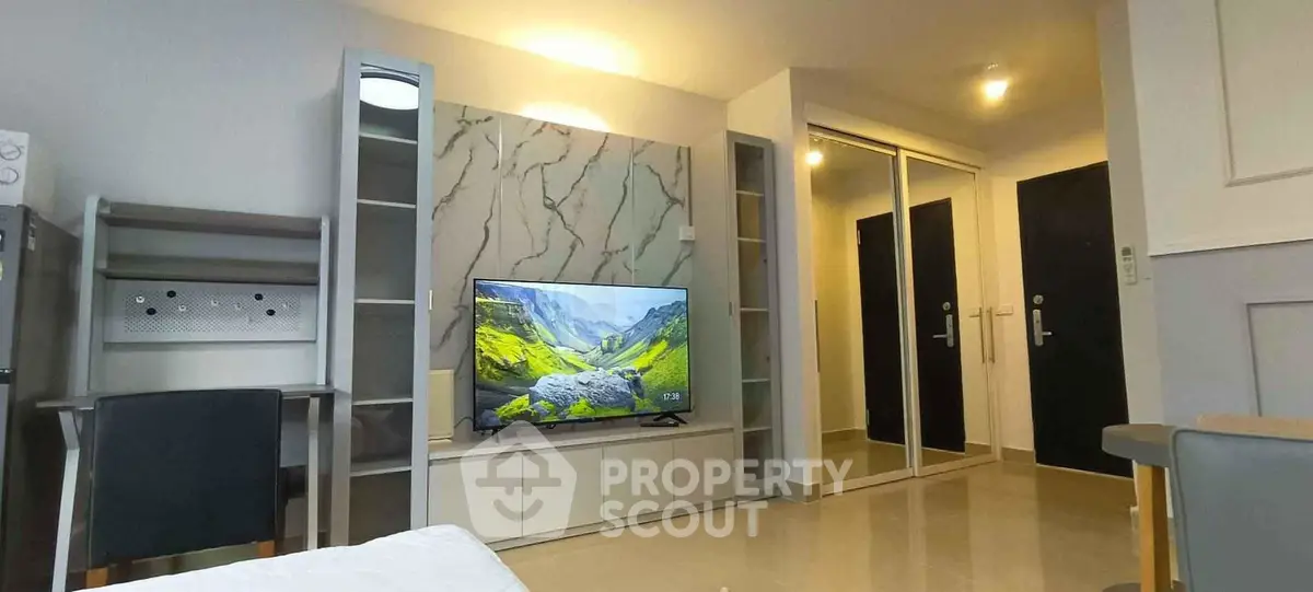 Modern living room with sleek TV unit and mirrored wardrobe doors