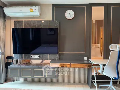 Modern living room with wall-mounted TV, air conditioning, and stylish decor