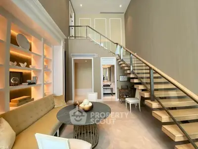 Luxurious living room with high ceilings, elegant staircase, and stylish decor in modern home.