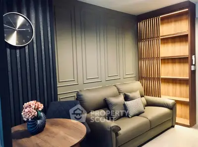 Stylish living room with modern decor, leather sofa, and elegant wall paneling.