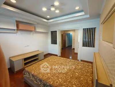 Spacious bedroom with modern lighting and stylish decor