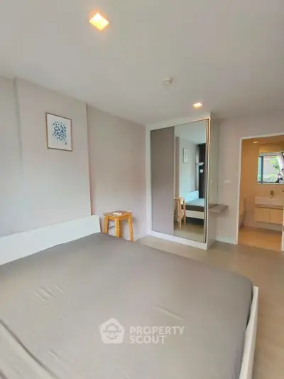 Modern bedroom with mirrored wardrobe and minimalist decor