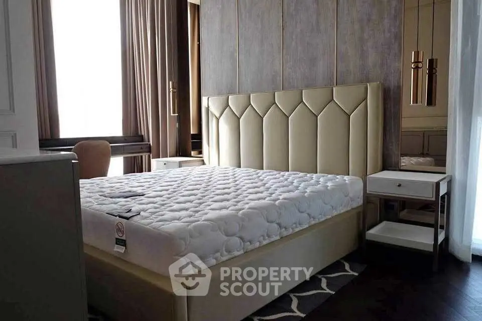 Luxurious bedroom with elegant headboard and modern decor, perfect for relaxation and comfort.