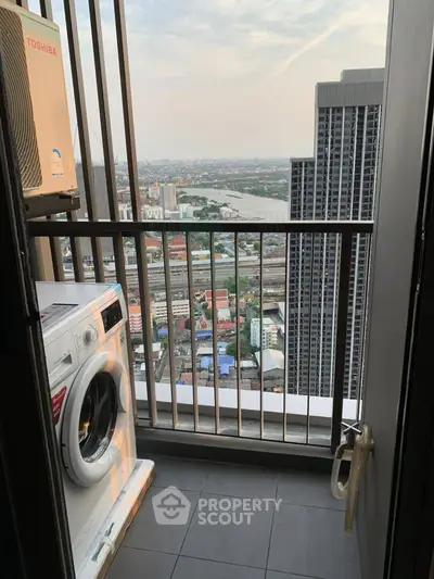 High-rise balcony with stunning city and river view, featuring a washing machine for convenience.