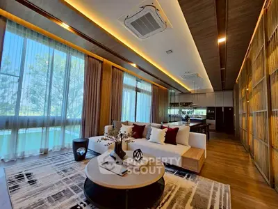 Luxurious modern living room with elegant decor and large windows offering scenic views.