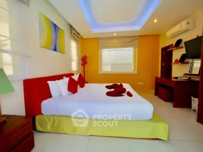Spacious modern bedroom with stylish decor and ambient lighting