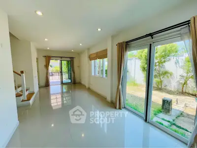 Spacious living room with large windows and garden view in modern home