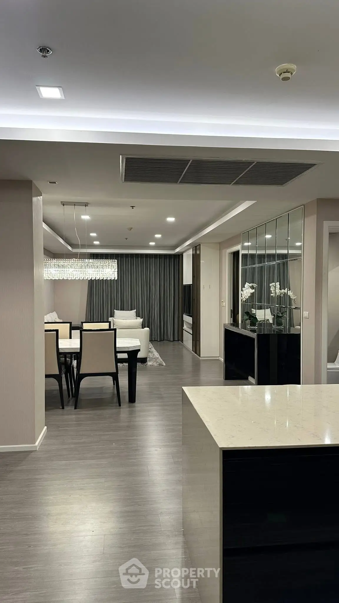 Luxurious modern living and dining area with elegant lighting and sleek design