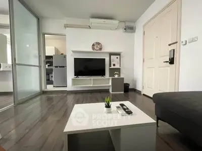 Modern living room with sleek design, featuring a TV, air conditioning, and stylish decor.
