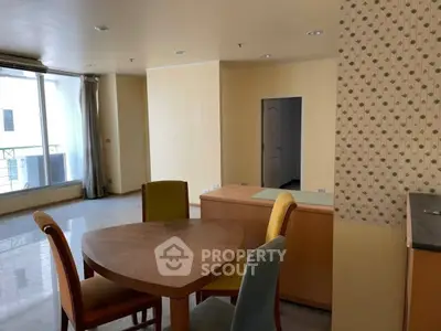 Spacious living room with modern dining area and large windows for natural light.