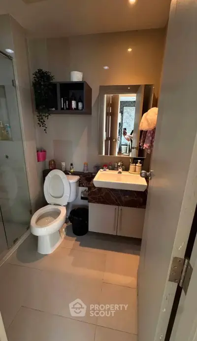 Modern bathroom with sleek fixtures and glass shower enclosure