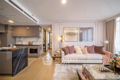 Luxurious modern living room with elegant decor and open kitchen layout.