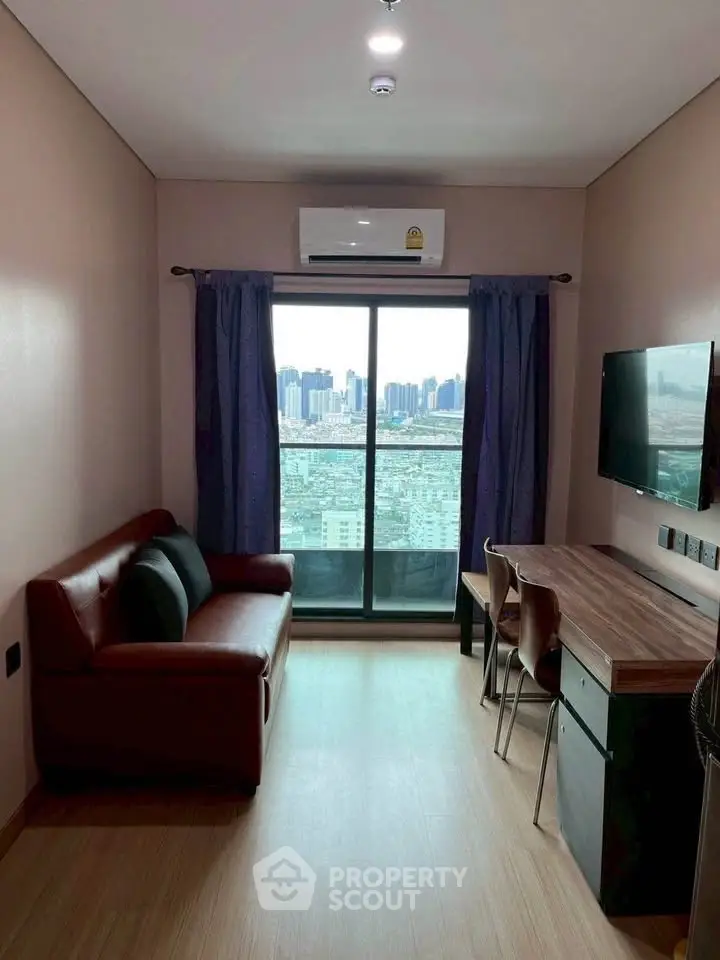 Modern living room with city view, cozy sofa, and sleek desk setup.