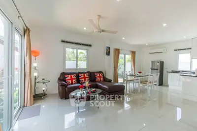 Spacious open-plan living room with modern decor and natural light