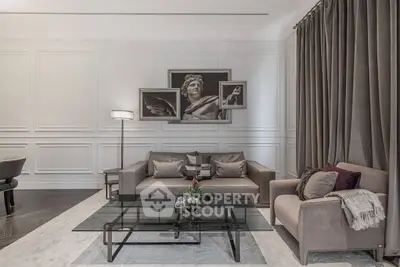 Elegant living room with modern decor, featuring a stylish sofa, glass coffee table, and artistic wall art.