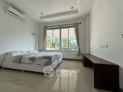 Spacious bedroom with large windows and modern minimalist design, perfect for natural light lovers.