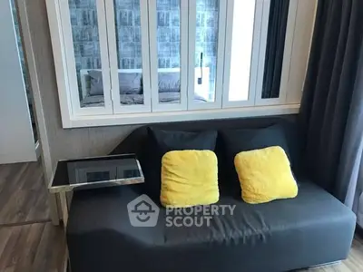 Modern living room with stylish sofa and vibrant yellow cushions