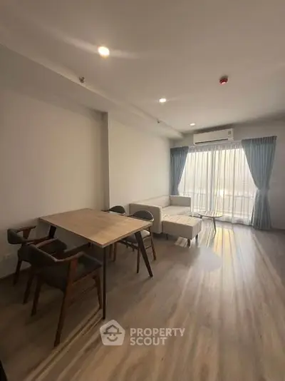 Spacious living room with modern furniture and large windows for natural light.