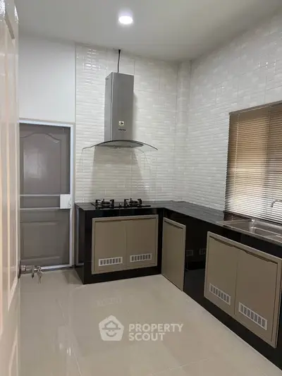 Modern kitchen with sleek cabinetry and gas stove in a stylish home
