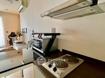 Modern kitchen with electric stove and microwave in stylish apartment