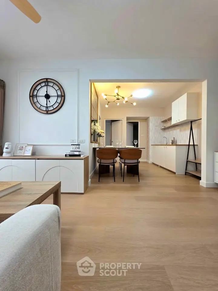 Spacious open-plan living and dining area with modern kitchen design and stylish decor.